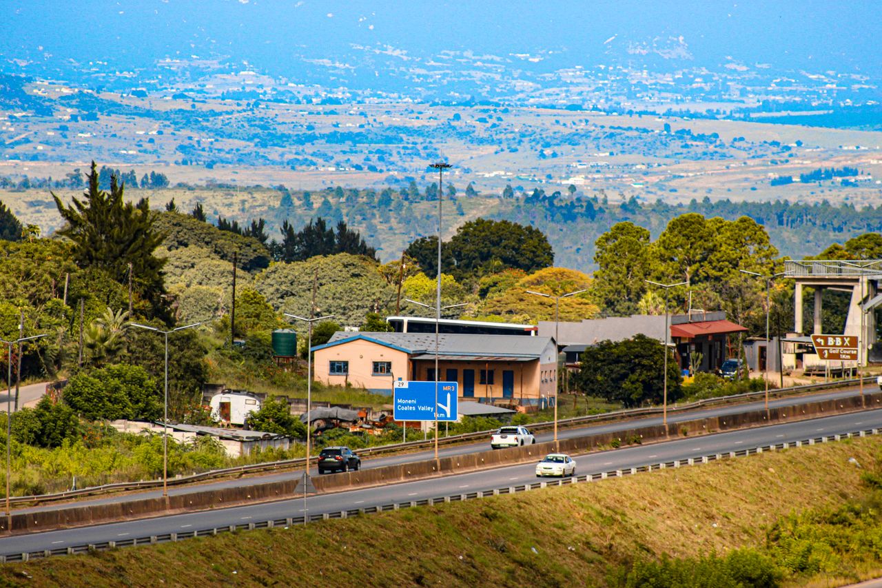 Mastering the First Impression: Your intriguing post title goes here Aerial view of a busy highway in Eswatini with lush greenery and distant hills.