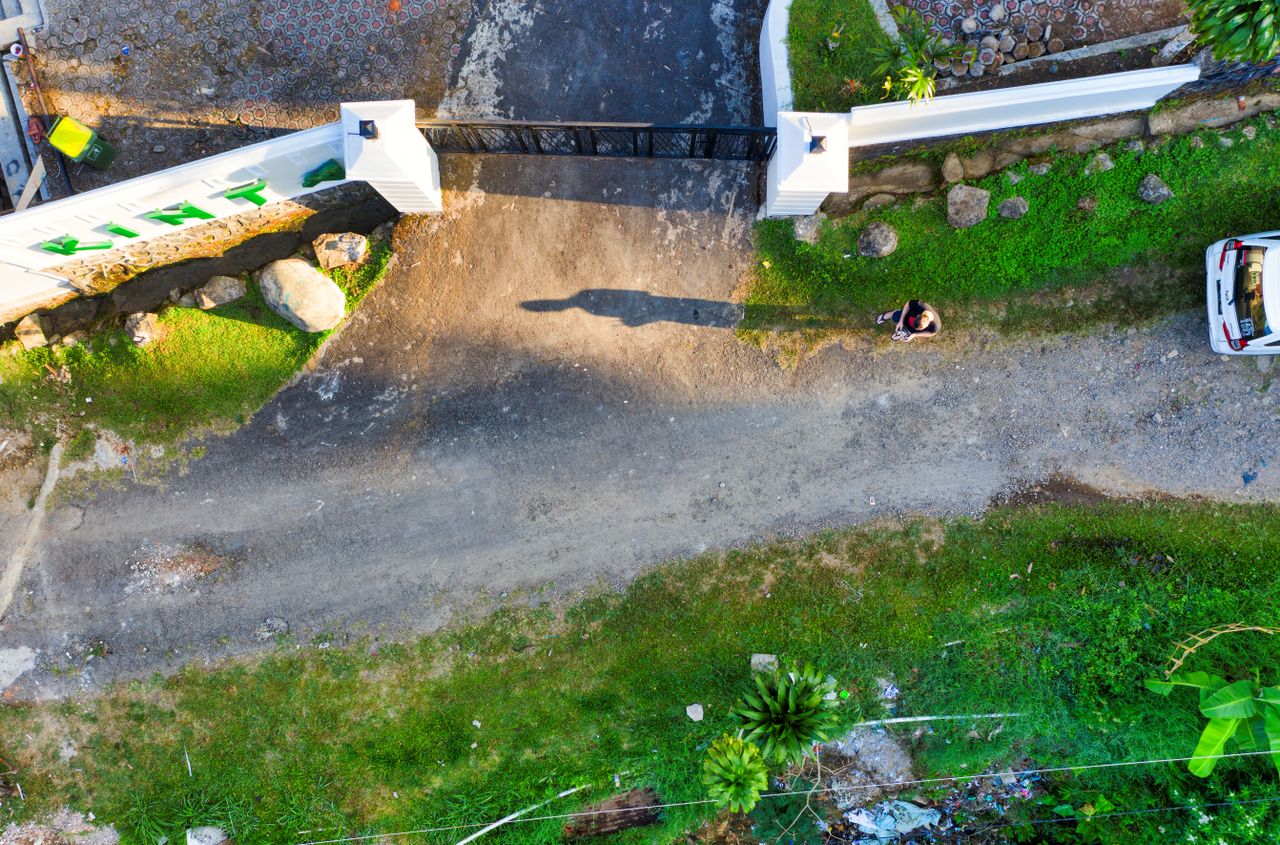 Crafting Captivating Headlines: Your awesome post title goes here Aerial view of a gated entrance and surrounding greenery in Cisarua, Indonesia.